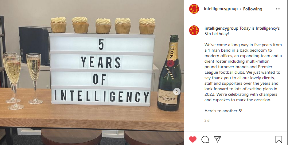 An Instagram screenshot depicting 3 glasses of champagne to the right of a lightbox which reads "5 YEARS OF INTELLIGENCY" and to the right is an opened bottle of Champagne.