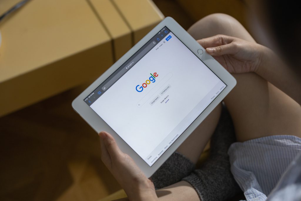 An image of a tablet with the Google homepage displayed. 