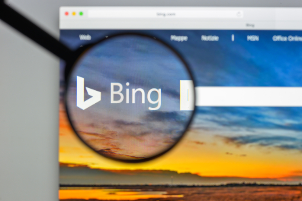 An image of a magnifying glass covering the Bing logo on a mac.