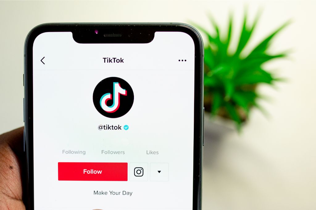 An image of the user profule for Tiktok being shown on a smartphone. 