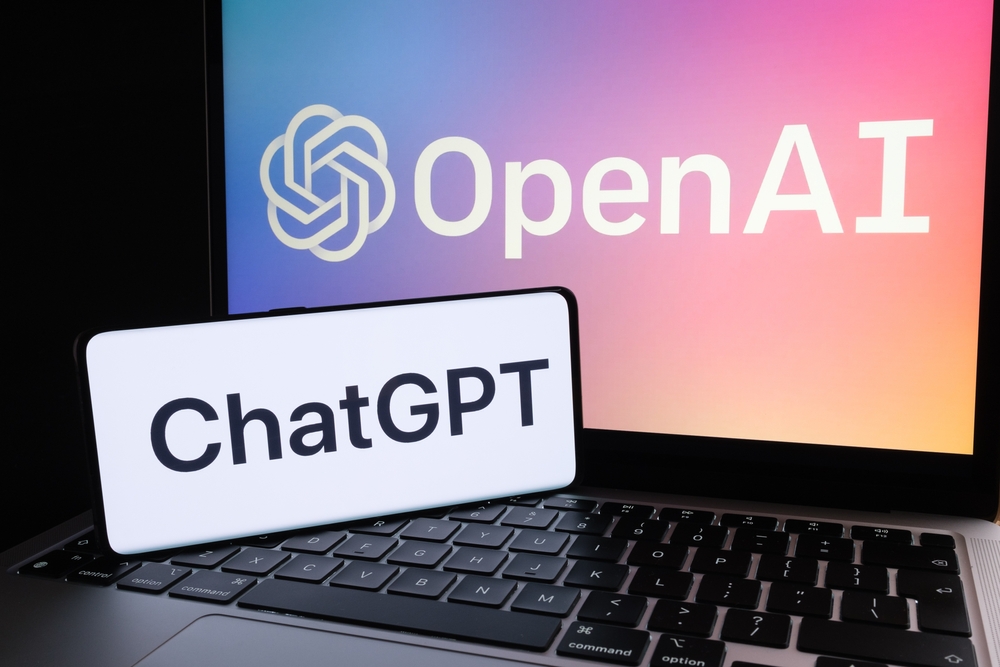 A phone screen reading "chatGPT" next to a laptop reading "OpenAI"