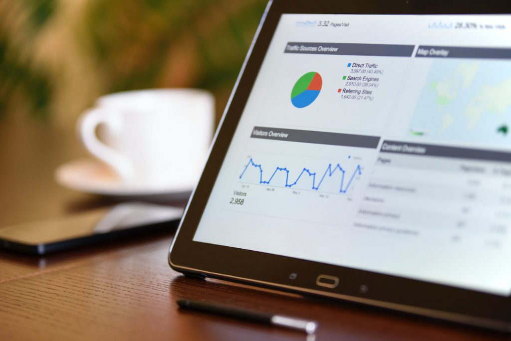 A laptop screen with different analytic data graphs showing such as website traffic data.