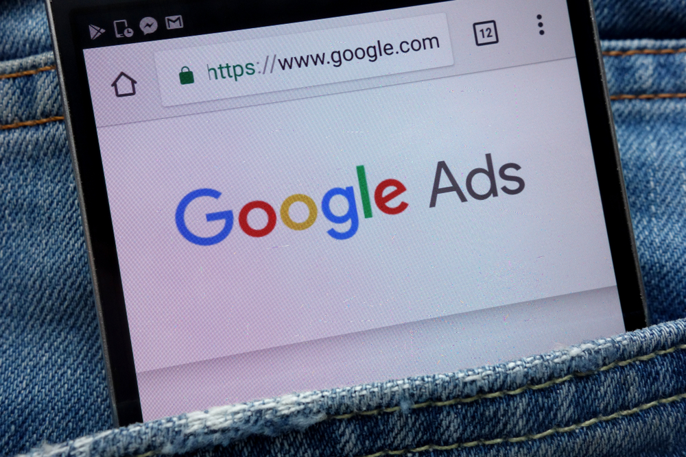 An image of a tablet reading "google ads" in someone's jean pocket.