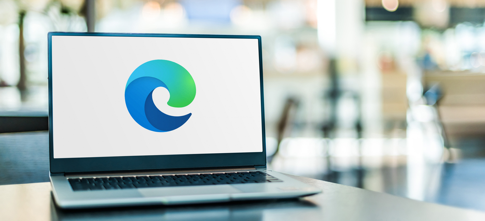 A laptop with the Microsoft Edge logo displayed.